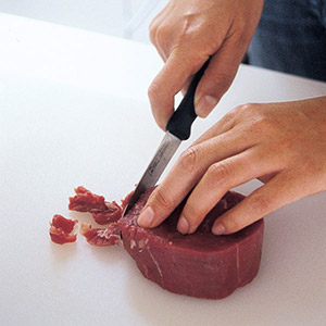 trimming fat off a steak