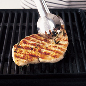 turning the chicken breast on the barbecue