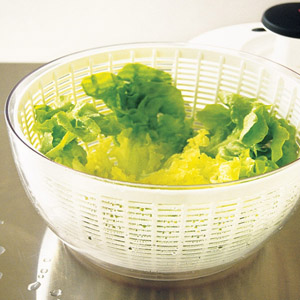 washing salad leaves in a colander