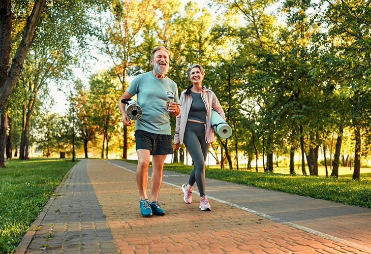 Elderly couple walking outdoors.