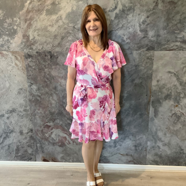 Deb's after photo, wearing a floral dress